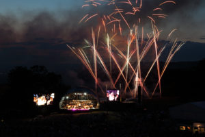 The stage looks small against the backdrop of a Fireworks display at Leeds Castle Classical Concert