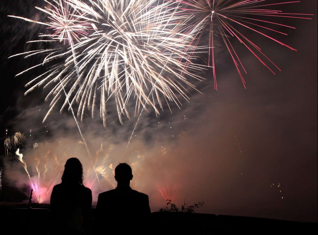 A wedding couple watching their wedding firework display