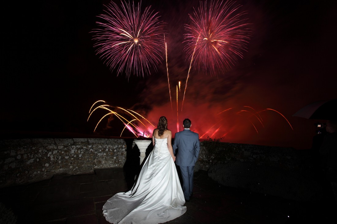 Wedding couple watching their professional fireworks display at Leeds Castle