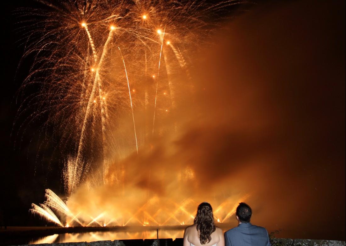 The sky full of gold glittering fireworks at a wedding fireworks display