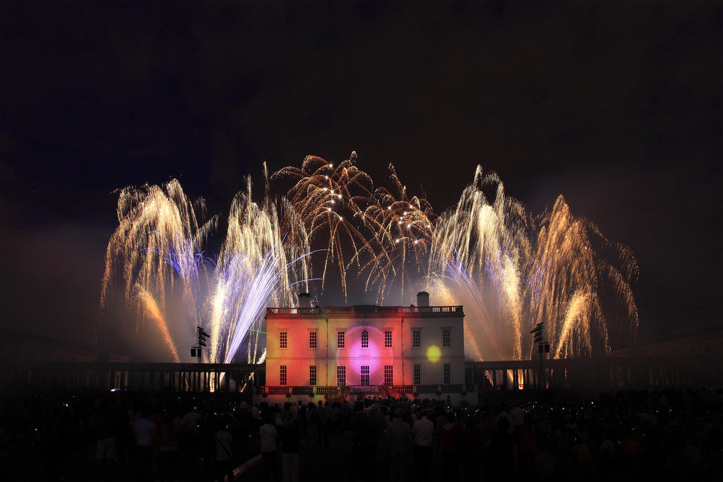 Fans of roman candles behind Queens House in Greenwich at a professional firework display