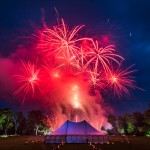 Bright red fireworks bursting over a marquee on the Isle of Bute