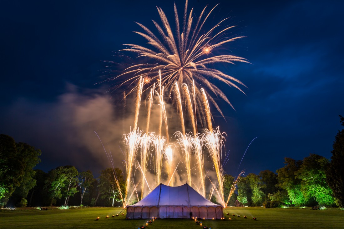 Gold and silver firework trails above a marquee in Scotland