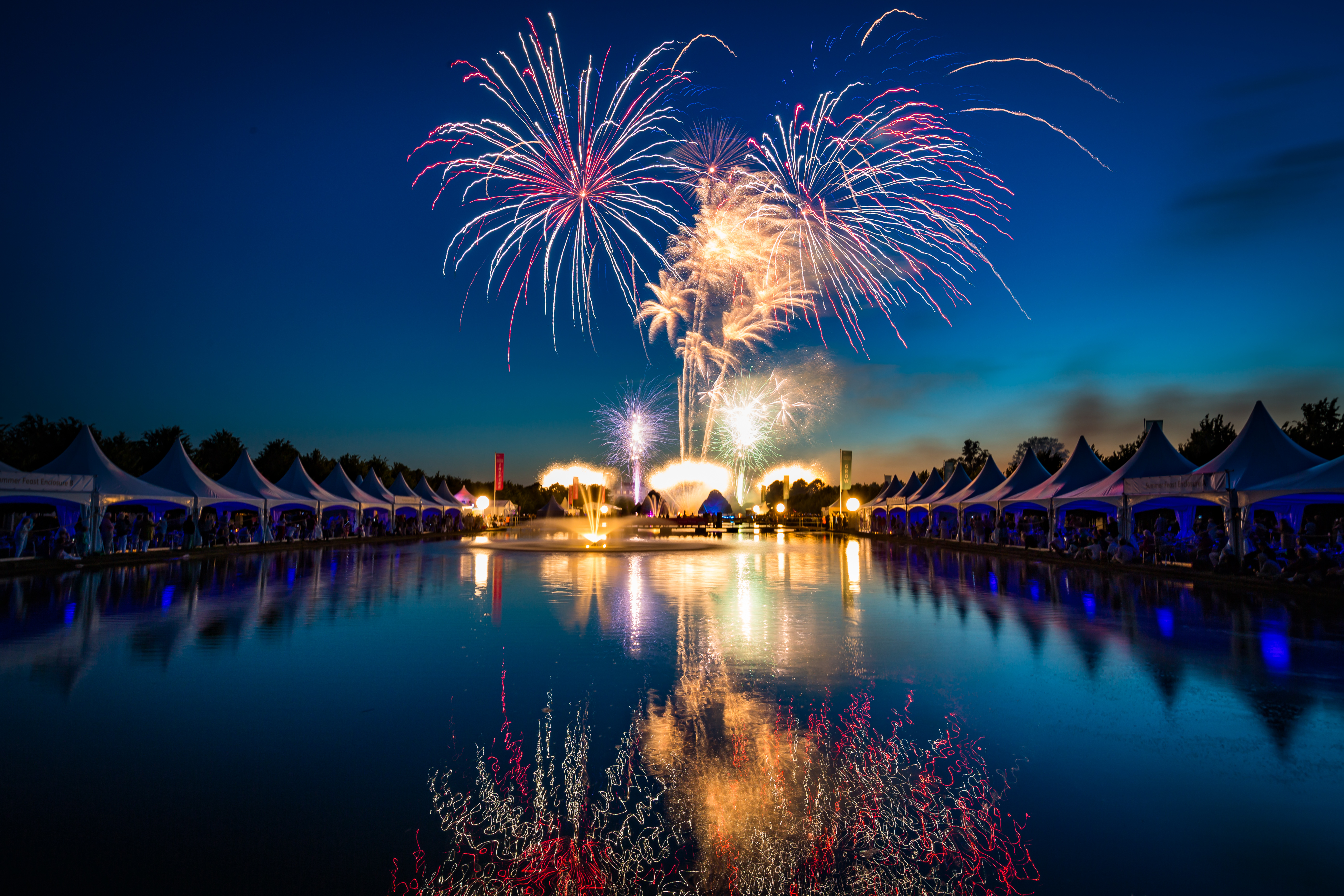 Fireworks reflections in the long water at Hampton Court Palace for the RHS Hampton Court Palace Flower Show