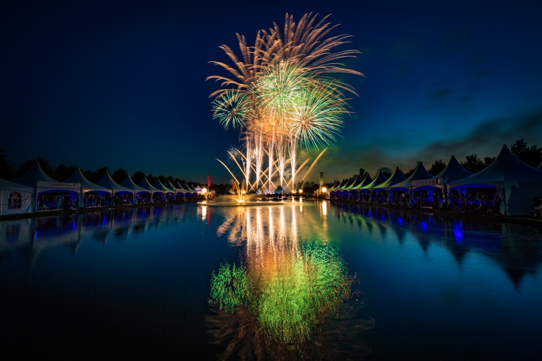 Gold and green fireworks at Hampton Court reflected in the long water