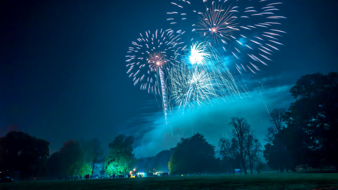 Beautiful blue fireworks bursting over Christchurch Park in Ipswich as part of a professional fireworks display