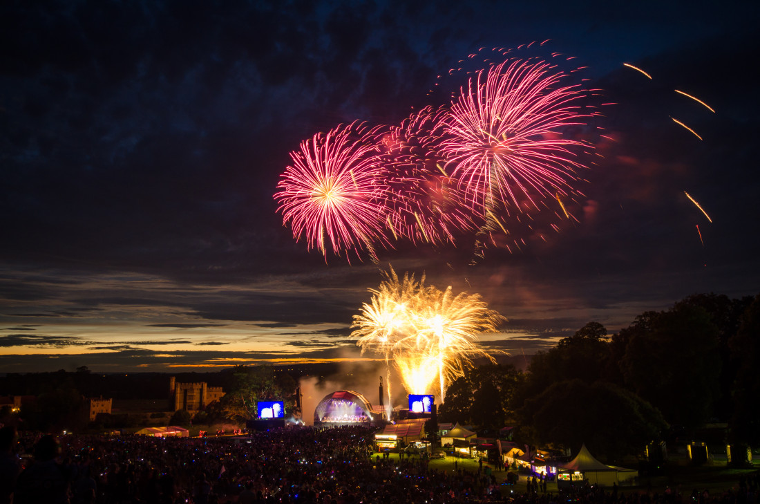 Pink and gold fireworks exploding in the sky for a classical concert