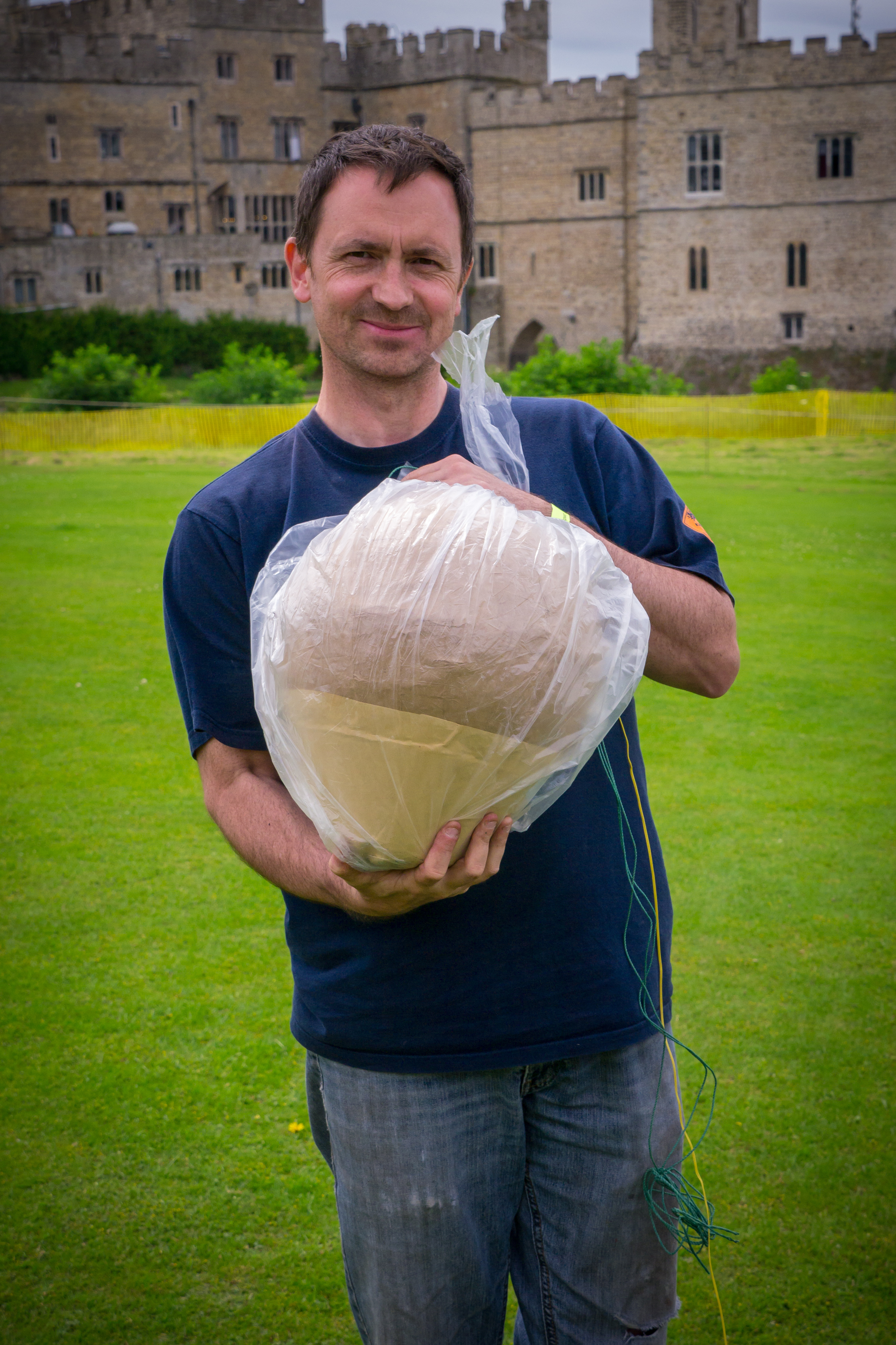 Alchemy Fireworks managing director holding a large firework shell at a classical concert where fireworks are choreographed to live music