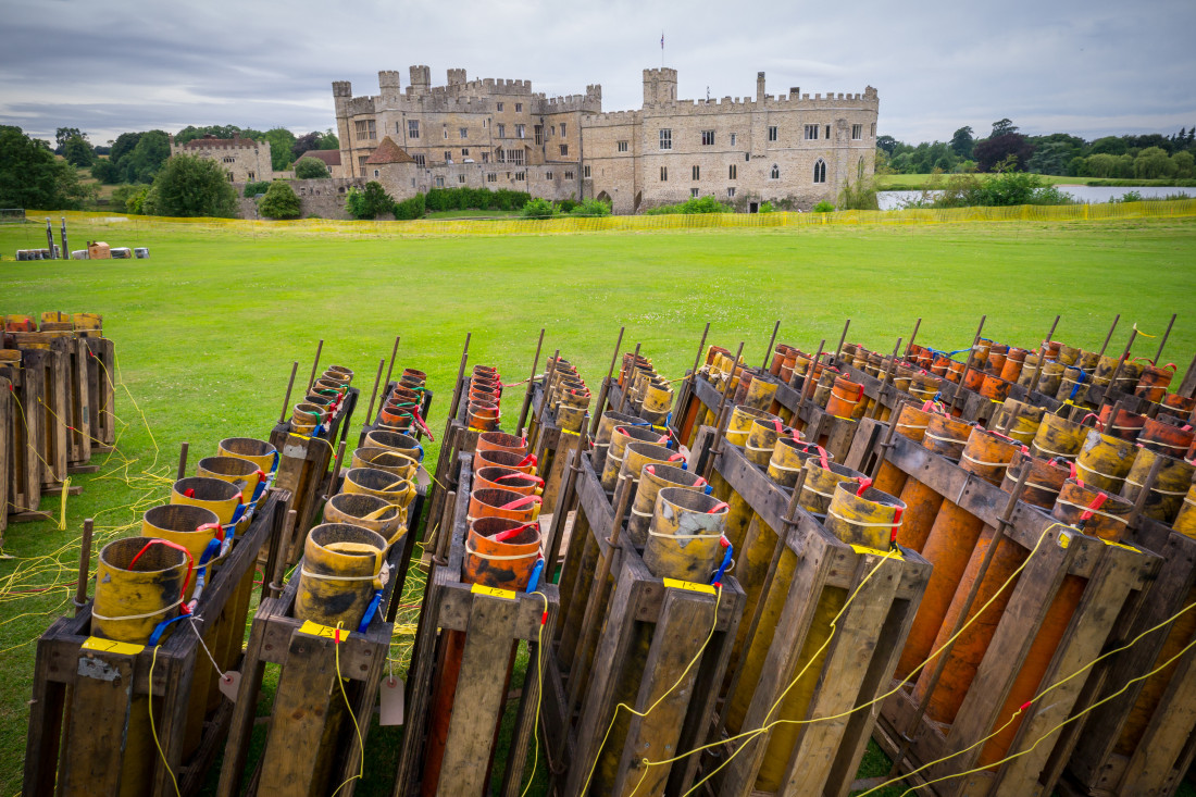 View across a large firework shell set-up at Leeds Castle classical concert